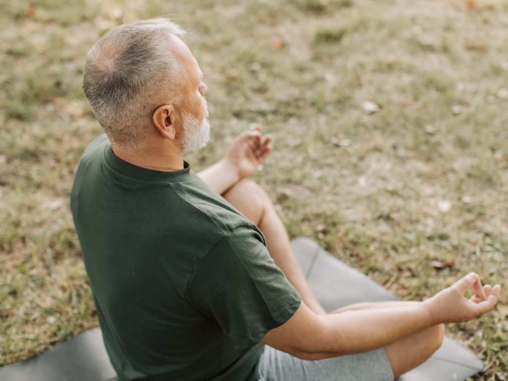 An elderly man practicing morning meditation