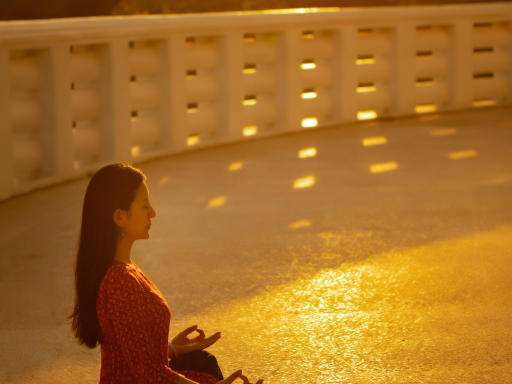 A woman in red dress performing morning meditation