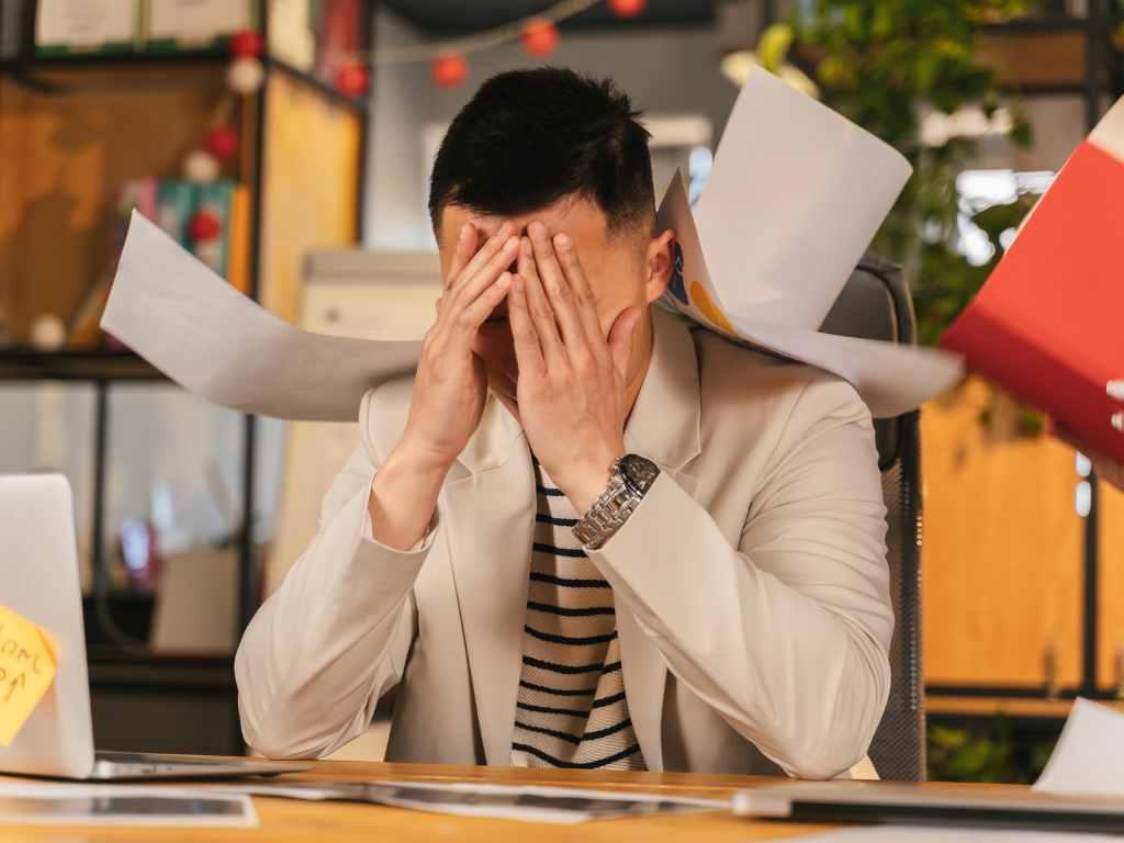 An image of a man dealing with Anxiety at workspace