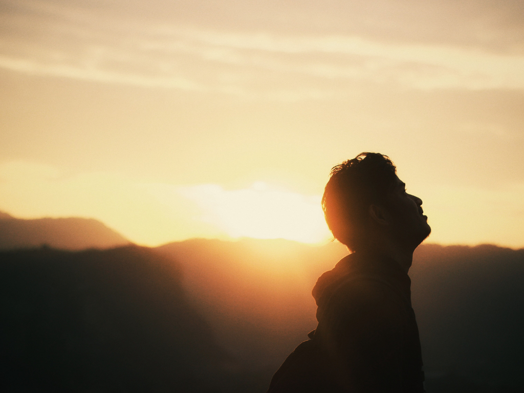 A silhouette image of a man taking much needed break from busy life