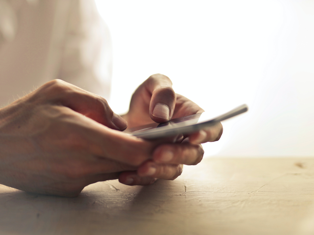 An image of a person using mobile in search of a meditation app