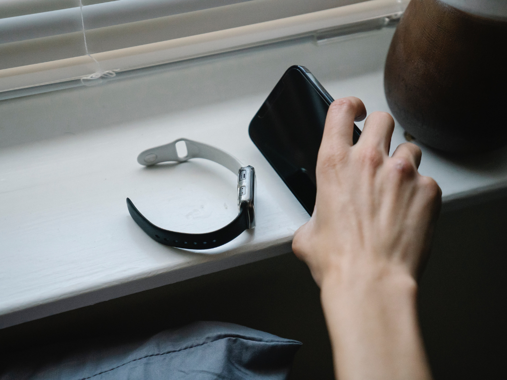 An image of a person using their phone and timer device. 